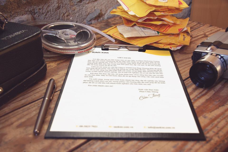 Documents and a pen on a boardroom desk